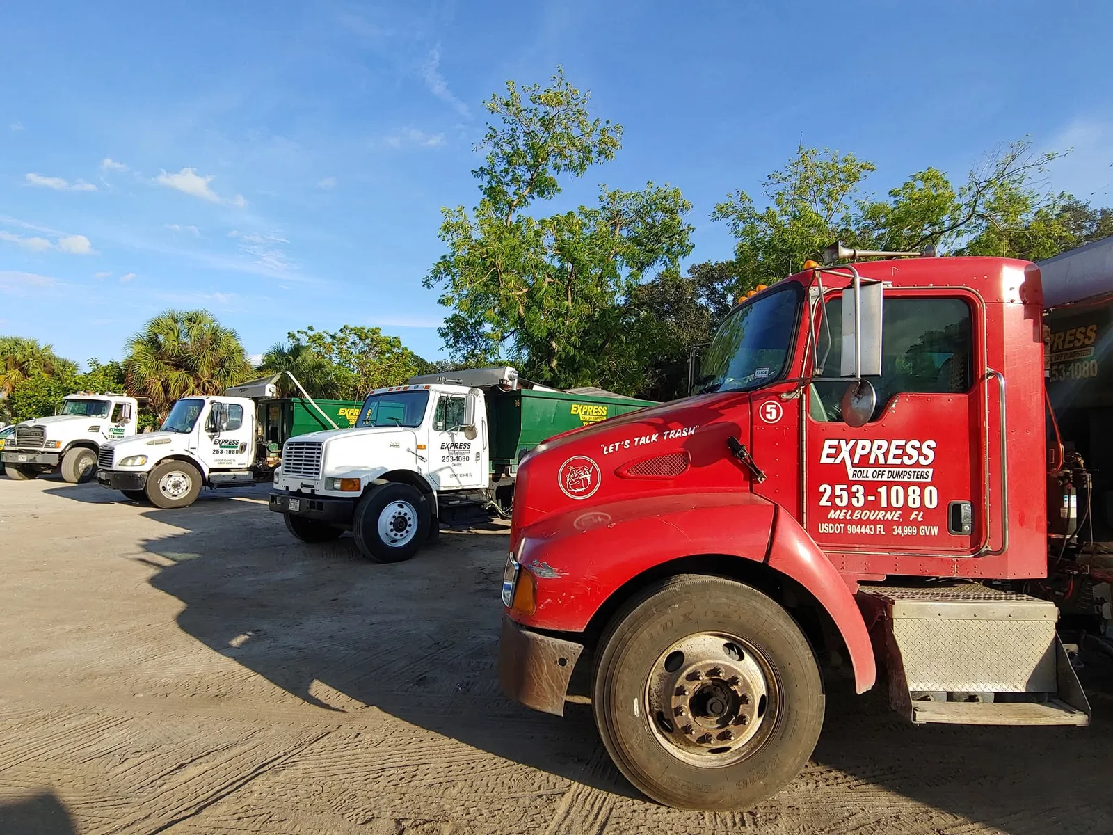 Experienced contractor managing debris flow with organized dumpster placement on active jobsite