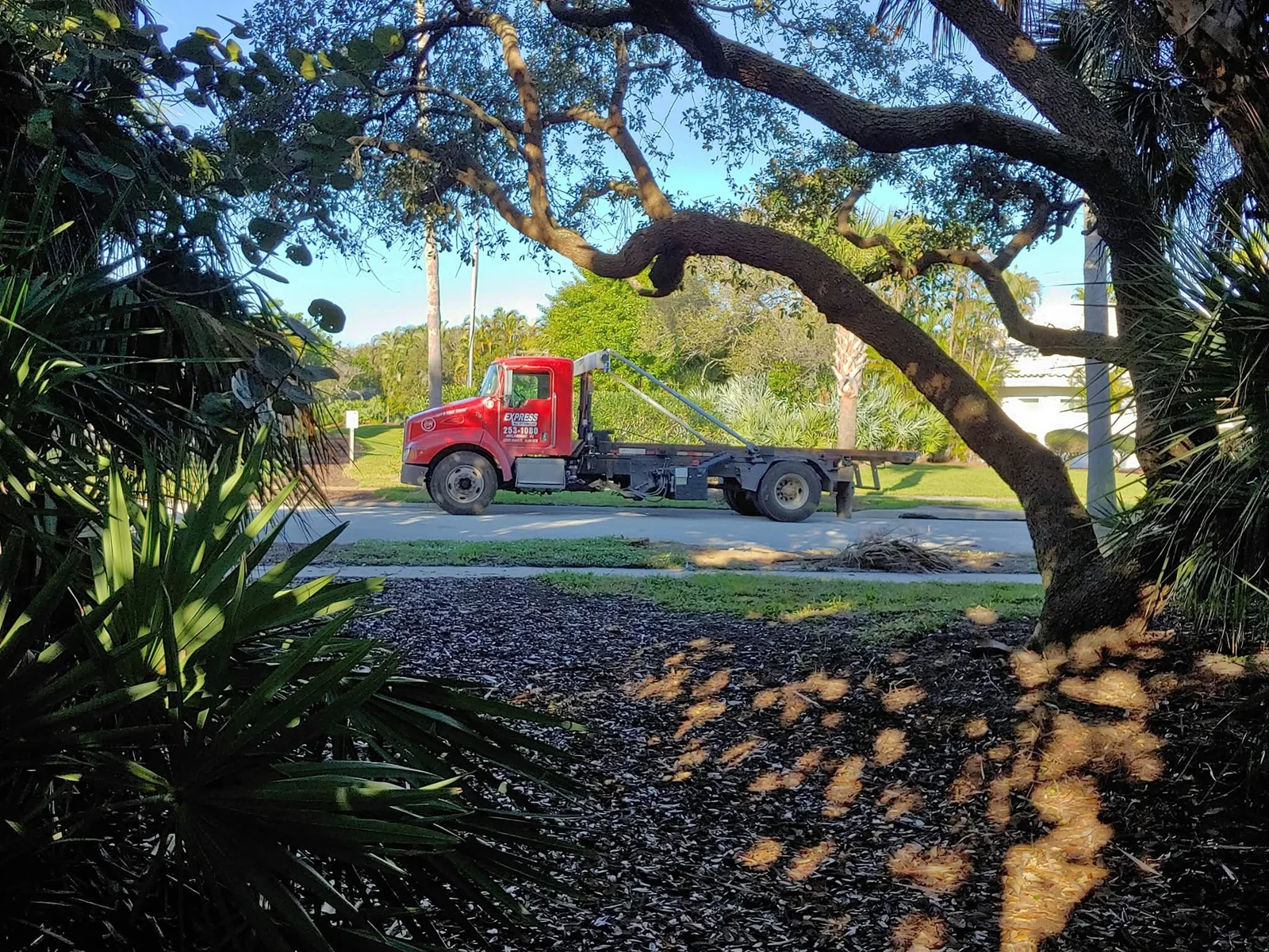 Experienced contractor managing debris flow with organized dumpster placement on active jobsite